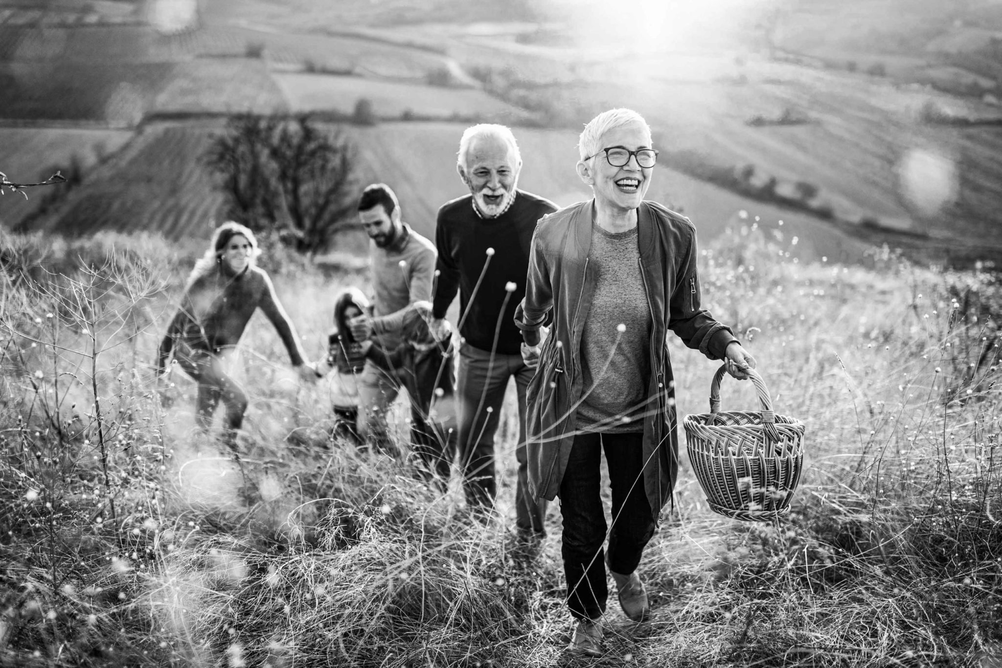 multi-generational family walking up a hill