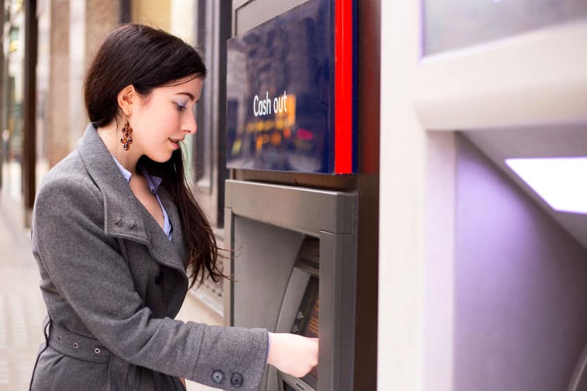 Young woman at an ATM machine