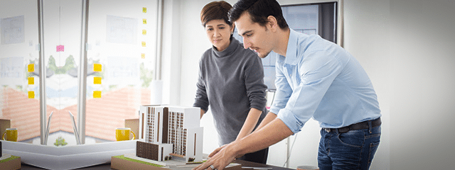 woman and man looking at building plans